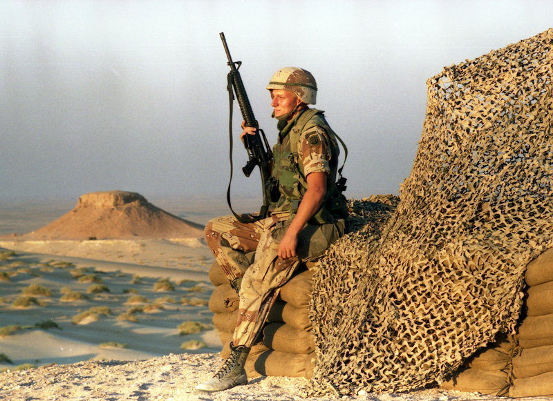 U.S. soldier rests while on guard at a relay station in the Saudi Arabian dessert (1990). AP